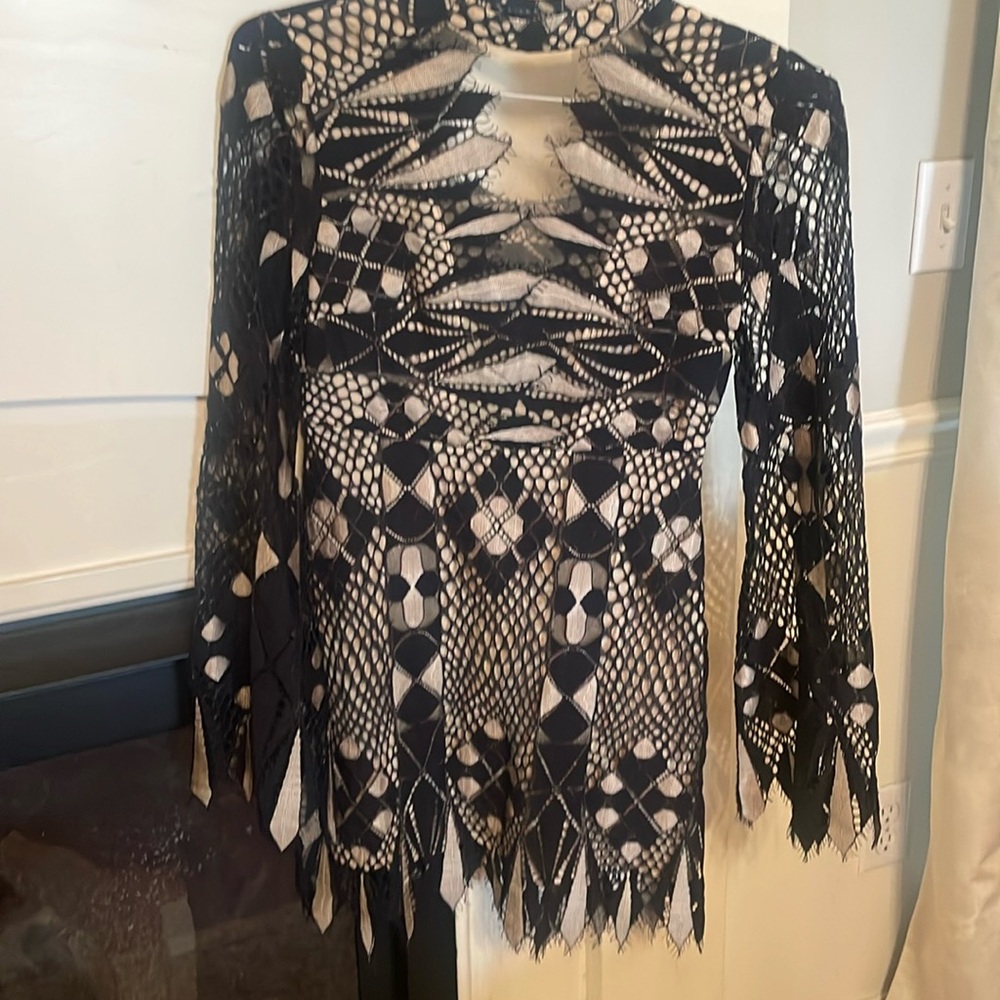 Black overlay on nude dress with bell sleeves
